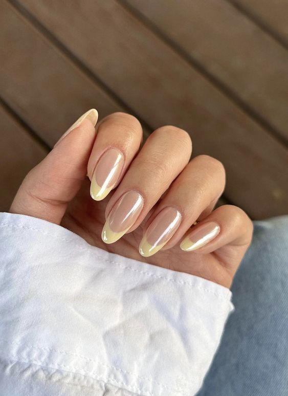 Yellow French tips of nails with chrome