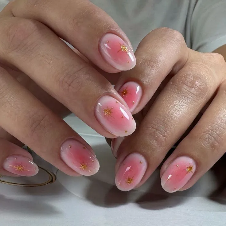 Light pink to dark pink aura nail with stickers