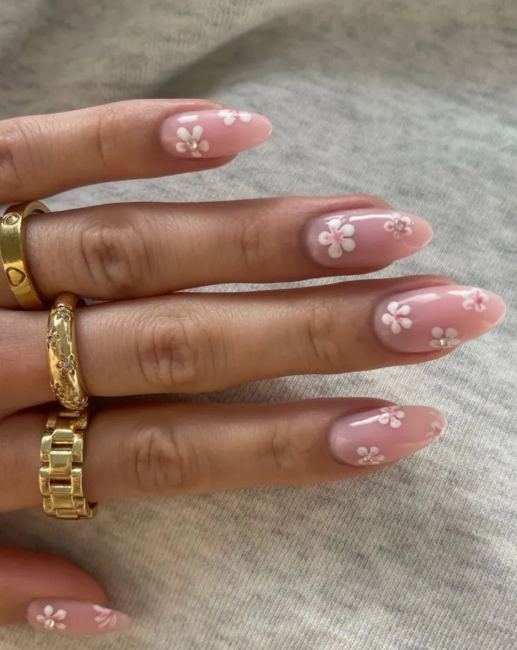 Pink floral nails with details of pearls and gems