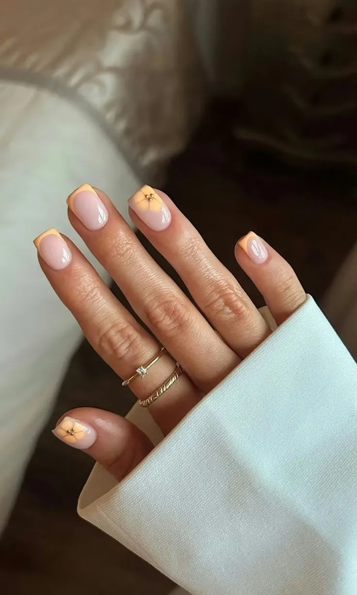 Orange French tips of nails with Hibiscus Flower
