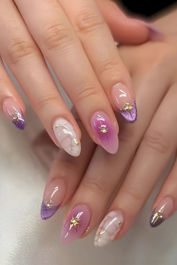 purple French nails with stickers on the stars